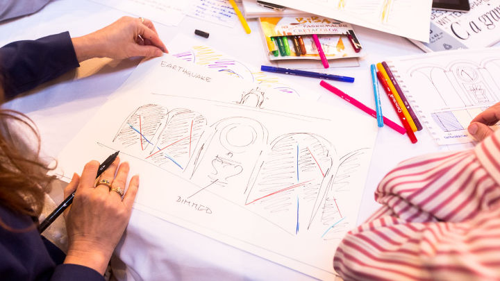 A woman is sketching during a workshop